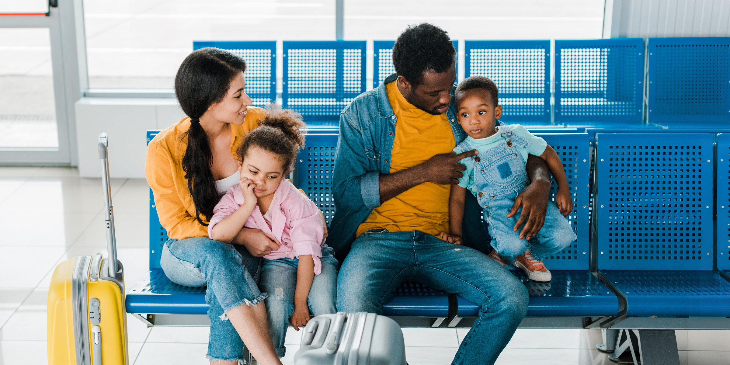 cheerful african american family with travel bags