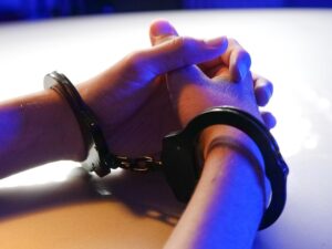 person with handcuffs on hands