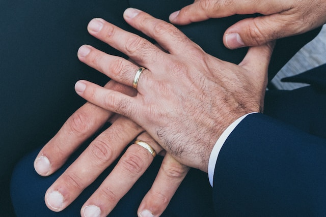 two men wearing wedding rings