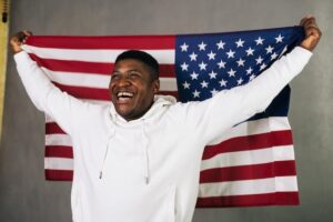 smiling man holding american flag