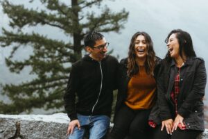 two women and a man laughing