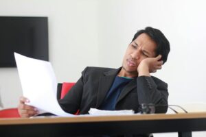 stressed man looking at document