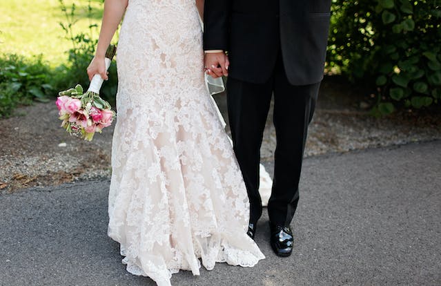 bride and groom holding hands