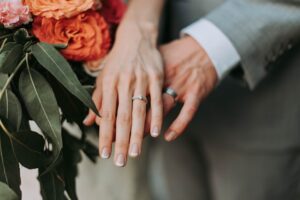 man and woman showing wedding rings