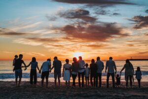 silhouette of family standing on beach