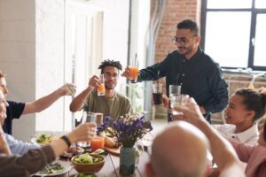 family members sitting around a table celebrating