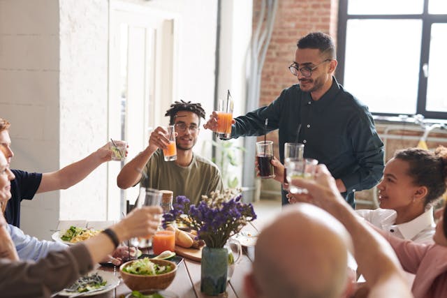 family members sitting around a table celebrating